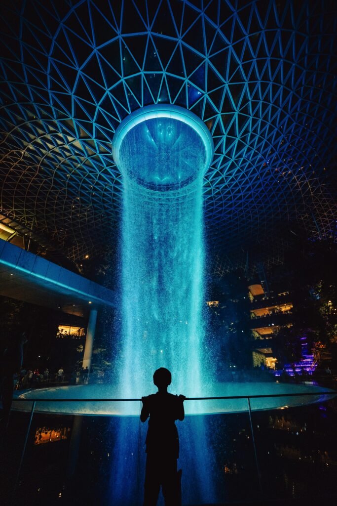 Illuminated Rain Vortex at night inside Jewel Changi Airport Singapore
